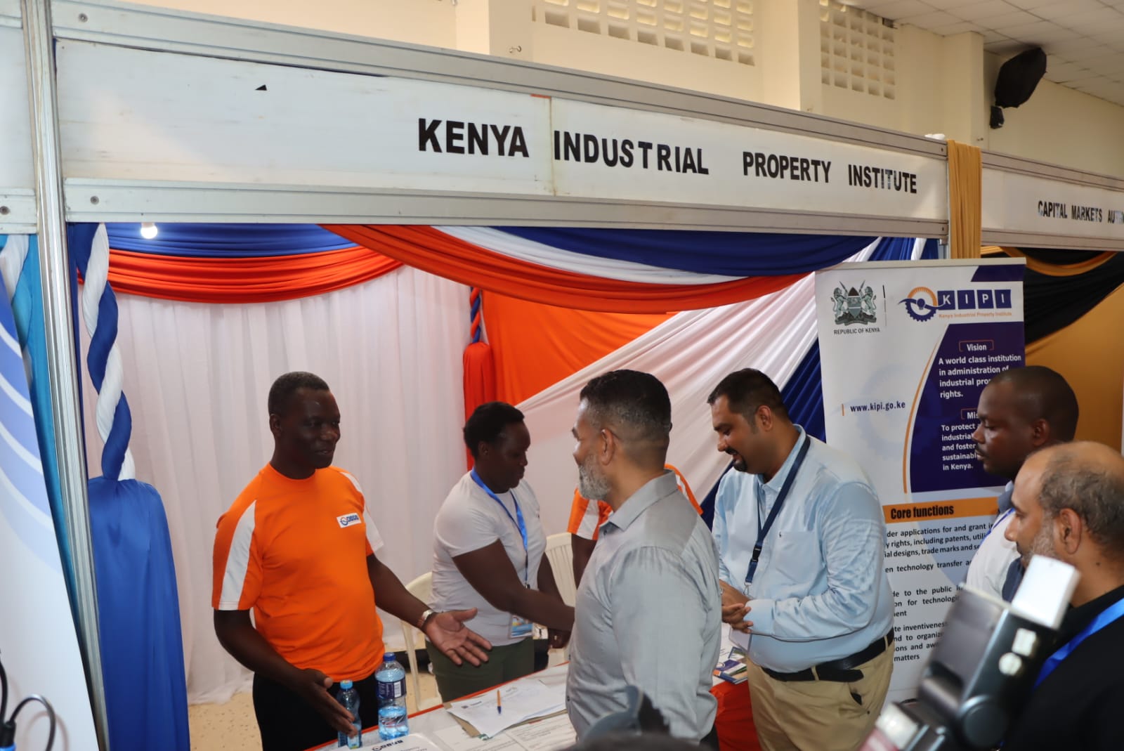 Erick Okoth (Left) of Trade Mark Division explains to H.E Abdulswamad Nasir, the Mombasa County Governor, the process and value of trade marks to manufacturers, including the micro, small and medium enterprises, during the Changamka Shopping Expo when the Governor toured the Institute's stand at the Oshwal Centre. The Expo was held from 30th November to 2nd December 2023. 